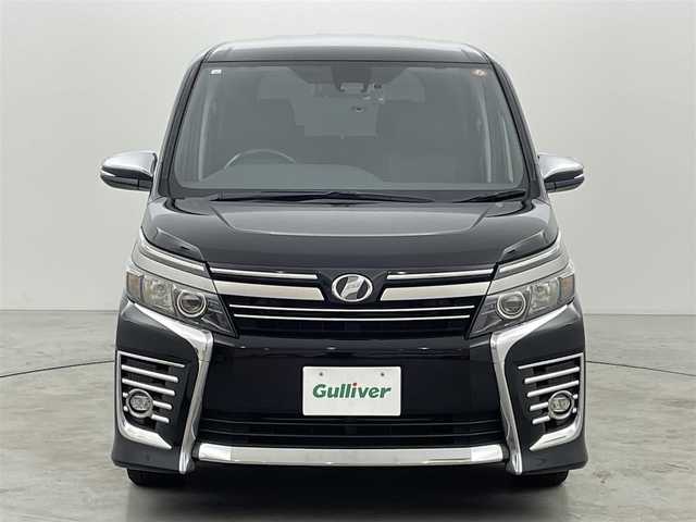 トヨタ ヴォクシー ZS 煌Ⅱ 福岡県 2016(平28)年 7.3万km ブラック 後席モニター　/純正９型ナビ（ＢＴ，フルセグＴＶ）　/バックカメラ　/前後ドラレコ　/ビルトインＥＴＣ　/衝突被害軽減ブレーキ　/レーンキープ　/アイドリングストップ　/ＭＴモード付き　/両側電動スライドドア　/ＬＥＤ