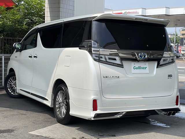 トヨタ ヴェルファイア ハイブリット ZR Gエディション 京都府 2018(平30)年 9万km ホワイトパールクリスタルシャイン ＪＢＬメーカーナビ/AM/FM/AUX/HDMI/USB/Bluetooth/フルセグＴＶ/（キャンセラー付き）/全方位モニター/サンルーフ/純正フリップダウンモニター/モデリスタフルエアロ/　（マフラーカッター）/三眼ＬＥＤヘッドライト/レーダークルーズコントロール/両側パワースライドドア/電動リアゲート/トヨタセーフティーセンス/LEDシグネチャーイルミブレード/デジタルミラー/ブラインドスポットモニター/メモリー付きパワーシート/デュアルエアコン/レザーシート/前席ベンチレーション/前席シートヒーター/ステアリングヒーター/ビルトイン2.0ETC/前方ドライブレコーダー/盗難防止装置/（社外セキュリティ）/100V電源/プッシュスタート/スマートキー/3列シート/オットマン/ウォークスルー/レーンキープアシスト/横滑り防止装置/前後コーナーセンサー/オートマチックハイビーム/AFS/（アダクティブフロントライティングシステム）/ダブルエアバッグ+サイドエアバッグ/フォグライト