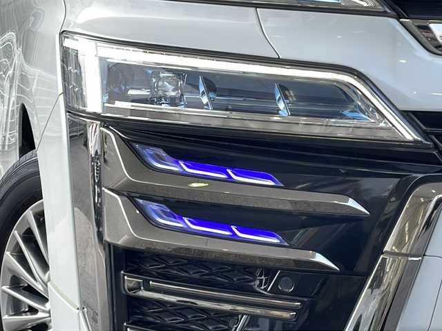トヨタ ヴェルファイア ハイブリット ZR Gエディション 京都府 2018(平30)年 9万km ホワイトパールクリスタルシャイン ＪＢＬメーカーナビ/AM/FM/AUX/HDMI/USB/Bluetooth/フルセグＴＶ/（キャンセラー付き）/全方位モニター/サンルーフ/純正フリップダウンモニター/モデリスタフルエアロ/　（マフラーカッター）/三眼ＬＥＤヘッドライト/レーダークルーズコントロール/両側パワースライドドア/電動リアゲート/トヨタセーフティーセンス/LEDシグネチャーイルミブレード/デジタルミラー/ブラインドスポットモニター/メモリー付きパワーシート/デュアルエアコン/レザーシート/前席ベンチレーション/前席シートヒーター/ステアリングヒーター/ビルトイン2.0ETC/前方ドライブレコーダー/盗難防止装置/（社外セキュリティ）/100V電源/プッシュスタート/スマートキー/3列シート/オットマン/ウォークスルー/レーンキープアシスト/横滑り防止装置/前後コーナーセンサー/オートマチックハイビーム/AFS/（アダクティブフロントライティングシステム）/ダブルエアバッグ+サイドエアバッグ/フォグライト