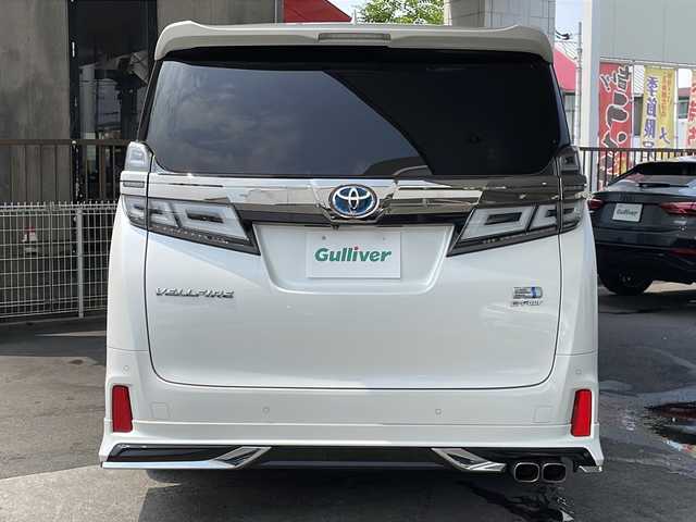 トヨタ ヴェルファイア ハイブリット ZR Gエディション 京都府 2018(平30)年 9万km ホワイトパールクリスタルシャイン ＪＢＬメーカーナビ/AM/FM/AUX/HDMI/USB/Bluetooth/フルセグＴＶ/（キャンセラー付き）/全方位モニター/サンルーフ/純正フリップダウンモニター/モデリスタフルエアロ/　（マフラーカッター）/三眼ＬＥＤヘッドライト/レーダークルーズコントロール/両側パワースライドドア/電動リアゲート/トヨタセーフティーセンス/LEDシグネチャーイルミブレード/デジタルミラー/ブラインドスポットモニター/メモリー付きパワーシート/デュアルエアコン/レザーシート/前席ベンチレーション/前席シートヒーター/ステアリングヒーター/ビルトイン2.0ETC/前方ドライブレコーダー/盗難防止装置/（社外セキュリティ）/100V電源/プッシュスタート/スマートキー/3列シート/オットマン/ウォークスルー/レーンキープアシスト/横滑り防止装置/前後コーナーセンサー/オートマチックハイビーム/AFS/（アダクティブフロントライティングシステム）/ダブルエアバッグ+サイドエアバッグ/フォグライト