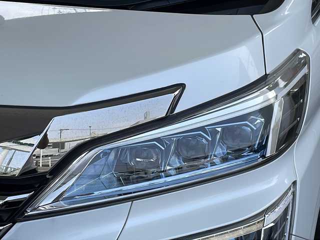 トヨタ ヴェルファイア ハイブリット ZR Gエディション 京都府 2018(平30)年 9万km ホワイトパールクリスタルシャイン ＪＢＬメーカーナビ/AM/FM/AUX/HDMI/USB/Bluetooth/フルセグＴＶ/（キャンセラー付き）/全方位モニター/サンルーフ/純正フリップダウンモニター/モデリスタフルエアロ/　（マフラーカッター）/三眼ＬＥＤヘッドライト/レーダークルーズコントロール/両側パワースライドドア/電動リアゲート/トヨタセーフティーセンス/LEDシグネチャーイルミブレード/デジタルミラー/ブラインドスポットモニター/メモリー付きパワーシート/デュアルエアコン/レザーシート/前席ベンチレーション/前席シートヒーター/ステアリングヒーター/ビルトイン2.0ETC/前方ドライブレコーダー/盗難防止装置/（社外セキュリティ）/100V電源/プッシュスタート/スマートキー/3列シート/オットマン/ウォークスルー/レーンキープアシスト/横滑り防止装置/前後コーナーセンサー/オートマチックハイビーム/AFS/（アダクティブフロントライティングシステム）/ダブルエアバッグ+サイドエアバッグ/フォグライト