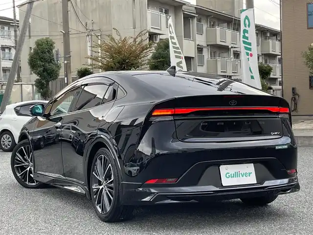 トヨタ プリウス Z 兵庫県 2023(令5)年 1.6万km アティチュードブラックマイカ ・ワンオーナー/・内装：アマチュアレッド/・モデリスタエアロ（NEO ADVANCE STYLE）//フロントスポイラー/サイドスカート//サイドガーニッシュ/リヤスタイリングキット//シグネチャーイルミ/・クールシャインキット//ヘッドライトガーニッシュ//サイドドアガーニッシュ//ドアハンドルガーニッシュ/・メーカーOP デジタルインナーミラー/・メーカーOP ドライブレコーダー前後/・メーカーOP 周辺車両接近時サポート/・メーカーOP ディスプレイオーディオ（コネクティッドナビ対応）Plus/・ディーラーOP HDMI入力端子/・地デジ/BT/USB/Miracast/・パノラミックビューモニター（床下透過式）/・ステアリングリモコン/・合皮シート（D席電動/前席ヒーター/ベンチレーション）/・ステアリングヒーター/・ワイヤレス充電器/・ビルトインETC/・AC100V電源/・パワーバックドア/・純正19インチAW//PCS/LTA/LDA/BSM/PDA/RSA//レーダークルーズコントロール/RCTA/RCD//SEA/PKSB/FCTA/LCA/AHB//Advanced Park/TMN//クリアランスソナー