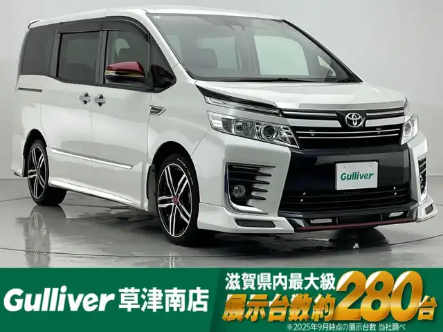 トヨタ ヴォクシー ZS 煌 滋賀県 2016(平28)年 8万km ホワイトパールクリスタルシャイン 社外エアロ（NOBLESSE）/社外１８AW（共豊）/社外メモリーナビ/【CD/DVD/USB/Bluetooth/フルセグ】/フリップダウンモニター/LEDヘッドライト/両側パワースライドドア/バックカメラ/スマートキー/ETC/オートハイビーム/レーンキープアシスト