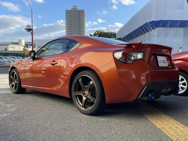 トヨタ ８６ GT リミテッド 兵庫県 2012(平24)年 12.9万km オレンジメタリック (株)IDOMが運営する【じしゃロン西宮店】の自社ローン専用車両になります。こちらは現金またはオートローンご利用時の価格です。自社ローンご希望の方は別途その旨お申付け下さい/＊ETC/＊バックカメラ/＊TRDタワーバー/＊GANADORマフラー/＊ADVAN　Racing18AW/＊フルセグ/＊シートヒーター/＊86専用シートカバー