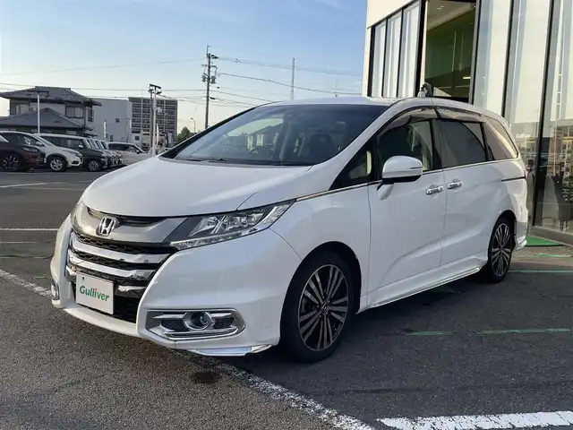 ホンダ オデッセイ アブソルート EX 長崎県 2015(平27)年 9.1万km ホワイトオーキッドパール 純正ナビ/（BT・USB・フルセグ・HDMI・DVD)/後席モニター/ホンダセンシング/レーンキープアシスト/レーダークルーズコントロール/両側パワースライドドア/ハーフレザーシート/運転席パワーシート/バックカメラ/ブラインドスポットモニター/パドルシフト/オートライト/LEDヘッドライト/パドルシフト/ビルトインETC/アイドリングストップ/スペアキー/新車保証書