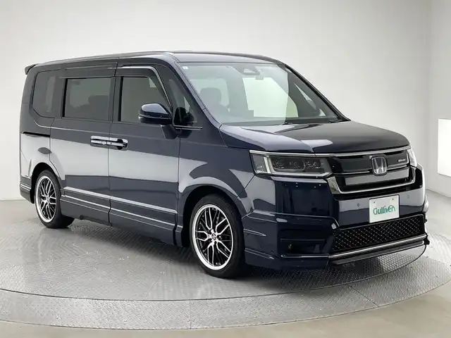 ホンダ ステップワゴン スパーダ eHEV 兵庫県 2023(令5)年 1.2万km ミッドナイトブルービームM 純正メモリナビ/（CD/DVD/SD/Bluetooth/USB/フルセグTV）/・LXM-237VFi/バックカメラ/アダクティブクルーズコントロール/LKA/ブラインドスポットモニター/コーナーセンサー（前後）/プリクラッシュセーフティー/横滑り防止装置/盗難防止装置/カーテンエアバッグ/純正フリップダウンモニター/デジタルインナーミラー/両側パワースライドドア/パワーバックドア/ハーフレザーシート/シートヒーター（D/N席）/パドルシフト/LEDフォグランプ/LEDヘッドライト/オートライト/ヘッドライトレベライザー/MTモード付AT/フルスポイラー（フロント/サイド/リア）/ドライブレコーダー（前後）/ETC/社外18インチアルミホイール/純正アルミホイール4本積込み有/社外フロアマット/純正ドアバイザー/スマートキー/3列シート/ウォークスルー