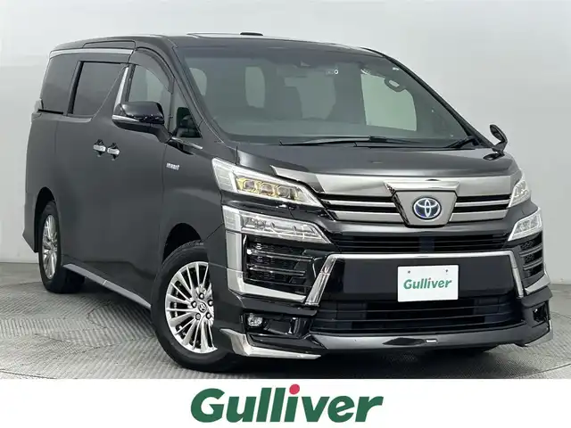 トヨタ ヴェルファイア ハイブリット Z ゴールデンアイズ 道央・札幌 2020(令2)年 6.8万km バーニングブラッククリスタルシャインガラスフレーク ・４WD/・モデリスタエアロ/・ディスプレイオーディオ/　ナビTVキット/CD/DVDデッキ/　BT/USB/Miracast/・バックカメラ/・前後ドライブレコーダー/・ビルトインETC/・トヨタセーフティセンス/・プリクラッシュセーフティ/・レーダークルーズコントロール/・レーンディパーチャーアラート/・クリアランスソナー/・オートハイビーム/・PKSB/・RSA/・両側パワースライドドア/・パワーバックドア/・ハーフレザーシート/・LEDヘッドライト/・フォグライト/・オートライト/・プッシュスタート/・スマートキー/・純正エンジンスターター/・純正フロアマット/・ドアバイザー
