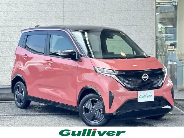 日産 サクラ X 兵庫県 2024(令6)年 0.3万km ピンク 純正9インチメモリーナビ/（CD/DVD/BT/フルセグTV）/全方位カメラ/衝突軽減ブレーキ/LEDヘッドライト/AUTOライト/フロアマット/ドアバイザー/スマートキー