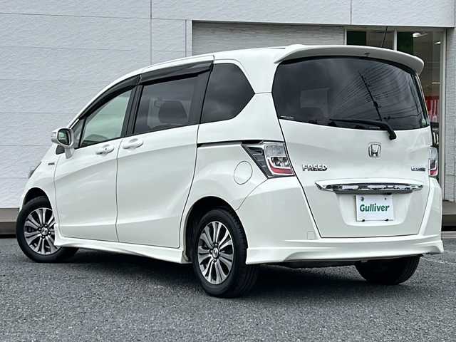 ホンダ フリード ハイブリット ジャストセレクション 千葉県 2012(平24)年 19.7万km プレミアムホワイトパール 純正ナビ/バックカメラ/クルーズコントロール/地デジ/ＥＴＣ/本革巻ハンドル/両側パワースライドドア/スマートキー/純正フロアマット/オートライト/純正アルミホイール/盗難防止装置/ハーフレザーシート