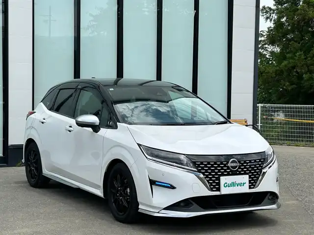 日産 ノート オーテック 大阪府 2021(令3)年 1.6万km ピュアホワイトパール / スーパーブラック 2トーン 純正９インチナビ/   フルセグTV/Bluetooth/USB/全方位モニター/衝突軽減ブレーキ/横滑り防止装置/コーナーセンサー/プロパイロット/ＢＳＭ/社外エアロ/スマートルームミラー/前席シートヒーター/ワイヤレス充電/100V電源/ドライブレコーダー/純正16インチアルミホイール/レザーシート/純正フロアマット/プッシュスタート/スマートキー/ＥＴＣ/ＬＥＤ