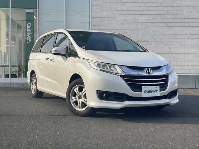 ホンダ オデッセイ G 岩手県 2016(平28)年 9.2万km ホワイトオーキッドパール 社外SDナビ/AM/FM/CD/DVD/Bluetooth/ワンセグTV/バックカメラ/ビルトインETC/ドライブレコーダー/両側パワースライドドア/クルーズコントロール/横滑り防止装置/アイドリングストップ/オートライト/LEDヘッドライト/スマートキー/プッシュスタート/電動格納ミラー/デジタルインナーミラー/社外16インチAW/16インチサマータイヤ(スチール)車載/純正フロアマット/ドアバイザー/保証書/取扱説明書