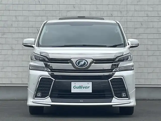 トヨタ ヴェルファイア ハイブリット ZR Gエディション 岩手県 2015(平27)年 7.5万km ホワイトパールクリスタルシャイン ・４WD/・純正ナビ フルセグTV　BT　DVD/・ムーンルーフ/・レザーシート/・モデリスタエアロ/・純正フリップダウンモニター/・JBLサウンド/・両側パワースライドドア/・バックカメラ/・パワーバックドア/・レーダークルーズコントロール/・ステアリングヒーター/・前席シートヒーター/・オートハイビーム/・ECOモード/・EVモード/・ナノイー/・ビルトインETC/・保証書/・取扱説明書/・スペアキー