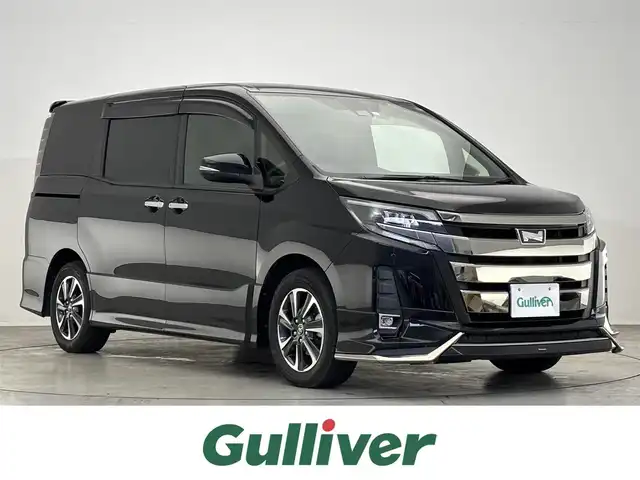 トヨタ ノア Si ダブルバイビー 滋賀県 2018(平30)年 6.7万km ブラック 禁煙車/純正10型ナビ/（CD/DVD/Bluetooth/フルセグTV)/モデリスタフロントエアロ/バックカメラ/両側パワースライドドア/ビルトインETC/前後ドライブレコーダー/ハーフレザーシート/LEDヘッドライト/オートライト/オートマチックハイビーム/プリクラッシュセーフティ/レーンディパーチャーアラート/先行車発進告知/前後ソナー/クルーズコントロール/アイドリングストップ/MTモード付AT車/プッシュスタート/スマートキー×２