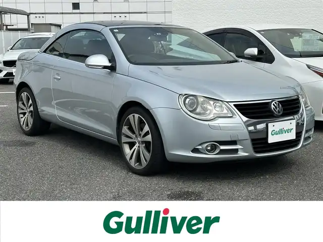 フォルクスワーゲン イオス 2．0T 愛知県 2007(平19)年 5.8万km シルバーエッセンスM ワンオーナー/電動オープン/バックソナー/クルーズコントロール/リモコンキー/ＡＡＣ/HDDナビ/ウィンカーミラー/電動サンルーフ/純正革シート/ETC/純正フォグランプ/ボンネットエアサス/保証書/取扱説明書