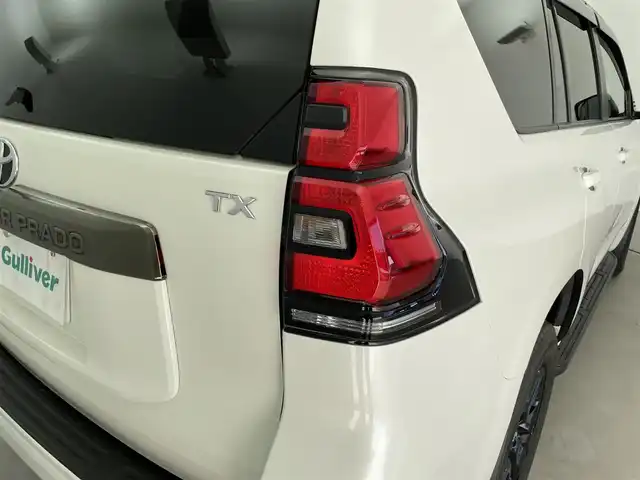 トヨタ ランドクルーザー プラド TX-L 70thアニバーサリーLTD 福井県 2022(令4)年 1.9万km ホワイトパールクリスタルシャイン 純正メーカーオプション９インチナビ/７人乗り仕様/寒冷地仕様　/全方位モニター　/プラドスーパーライブサウンド　　/サドルタン快適温熱レザーシート/純正１８インチアルミホイール　/純正スターター　/純正ビルトインＥＴＣ２．０/純正LEDヘッドライト/純正LEDフロントフォグ/フロントシールドデアイサー/ブラックルーフレール/JAOS製フロントスキッドバー/コンビハンドル/トヨタセーフティセンス/社外マフラー