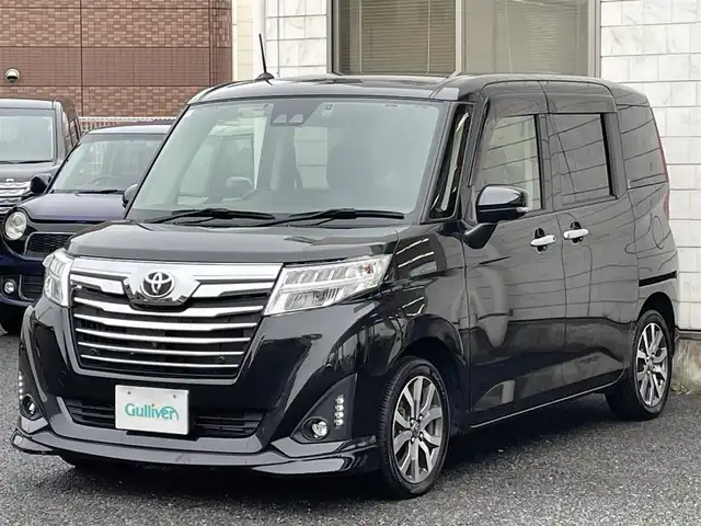 トヨタ ルーミー カスタムG－T 福岡県 2019(平31)年 2.7万km ブラックマイカメタリック ワンオーナー/純正9インチメモリナビ【NSZT-Y68T】/　(AM/FM/CD/DVD/Bluetooth/フルセグTV)/純正12.1インチフリップダウンモニター/全方位モニター/フロント・バックモニター/両側パワースライドドア/スマートアシストIII/・衝突警報機能/・衝突回避支援ブレーキ/・誤発進抑制制御機能/・車線逸脱警報/・先行車発進お知らせ機能/・オートハイビーム/横滑り防止機能/純正前方ドライブレコーダー【DRT-H68A】/クルーズコントロール/ビルトインETC/純正15インチアルミホイール/前席シートヒーター/後席ロールサンシェード/後席シートバックテーブル/純正フロアマット/スペアキー×1/保証書/取扱説明書/ナビ取扱説明書