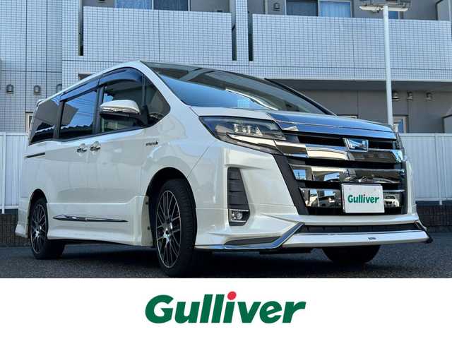 トヨタ ノア ハイブリッド Si 愛知県 2017(平29)年 7.5万km ホワイトパールクリスタルシャイン モデリスタエアロ/ワンオーナー/純正10型ナビ【Bluetooth CD DVD SD フルセグ　品番：NSZN-Z66T】/GPSレーダー探知機【品番：AR-３３】/ドライブレコーダー/ビルトインETC /バックカメラ/両側パワースライドドア/クルーズコントロール/衝突軽減ブレーキ/レーンキープアシスト/車両接近通報装置/先行車発進告知/LEDヘッドライト/オートライト/オートマチックハイビーム/フォグランプ/オート電動格納ドアミラー/ステアリングリモコン/ドアバイザー/スマートキー/禁煙車