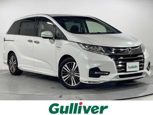 ホンダ オデッセイ ハイブリッド アブソルート・EXホンダセンジング 広島県 2020(令2)年 4.1万km プラチナホワイトパール 純正9型ナビ/純正フリップダウンモニター/マルチビューカメラ/両側パワースライドドア/パワーシート/シートヒーター/2列目オットマン/ホンダセンシング/・衝突軽減ブレーキ/・レーンキープアシスト/・アダプティブクルーズコントロール/・誤発進抑制機能/スマートパーキングアシスト/ブラインドスポットモニター/後退出庫サポート/電動パーキングブレーキ/オートブレーキホールド/LEDヘッドランプ/純正17インチAW/ETC2.0/ドライブレコーダー/AC100V/1500W電源