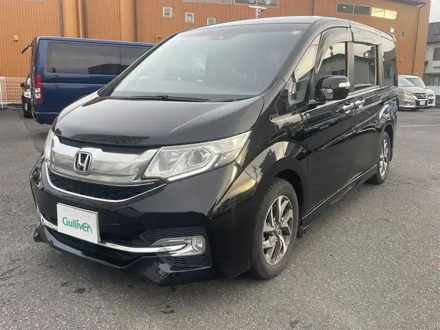 ホンダ ステップワゴン スパーダ ホンダセンシング 静岡県 2017(平29)年 6.5万km プレミアムスパークルブラックパール ワンオーナー/ホンダセンシング/・CMBS（衝突軽減ブレーキ）/・アダプティブクルーズコントロール/・LKAS（車線維持支援システム）/・先行発進お知らせ機能/・標識認識機能/・路外逸脱抑制機能/純正メモリナビ/・フルセグ/Bluetooth/SD/DVD/CD/バックカメラ/両側パワースライドドア/スマートキー2個/プッシュスタート/２列目サンシェード/ステアリングリモコン/オートライト/ETC/純正１６インチAW/純正フロアマット/新車時保証書/取扱説明書