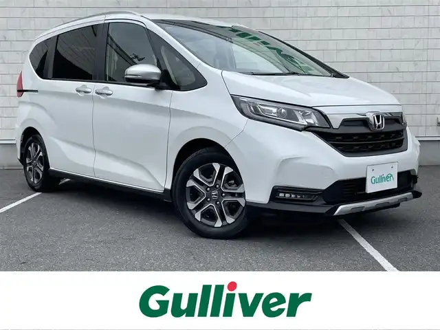 ホンダ フリード クロスター ホンダセンシング 栃木県 2021(令3)年 2.3万km プラチナホワイトパール ワンオーナー /禁煙車/純正9インチナビ/（フルセグTV/BT/CD/DVD/SD）/バックモニター/レーダークルーズコントロール/衝突軽減システム/レーンキープアシスト/コーナーセンサー/両側パワースライドドア/ルーフレール /ハーフレザーシート/前席シートヒーター/前後ドライブレコーダー/スマートキー/オートライト/LEDヘッドライト/フォグランプ/ビルドインETC/純正15インチAW/保証書/取説