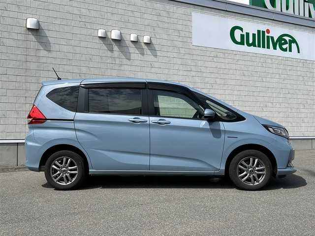 ホンダ フリード ハイブリット G ホンダセンシング 山形県 2020(令2)年 5.7万km シーグラスブルーパール ４WD/SDナビ/フルセグTV/AM/FM/iPod/USB/SD/Bluetooth/クルーズコントロール/ホンダセンシング/両側パワースライドドア/衝突軽減ブレーキ/横滑り防止装置/シートヒーター/ドライブレコーダー/バックカメラ/盗難防止装置/ダブルエアバック/純正マット/純正バイザー/AUTOライト/LEDライト/スマートキー/保証書