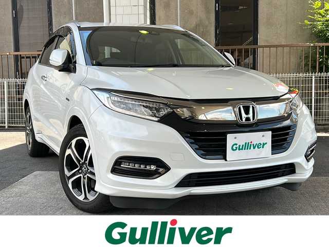 ホンダ ヴェゼル ハイブリッド Z ホンダセンシング 京都府 2020(令2)年 7.4万km パール ワンオーナー /ホンダセンシング/衝突軽減ブレーキ/路外脱却抑制装置/車線維持支援システム/純正メーカーOPSDナビ　/フルセグTV　/禁煙車　/バックカメラ　/LEDライト　/クルーズコントロール　/パドルシフト　/スマートキー　/前方シートヒーター/ハーフレザー　/前方純正ドライブレコーダー/純正AW17インチ/ウィンカーミラー/ビルトインETC/パワーウィンドウ/パワーステアリング/スペアキー有/CD/DVD再生機能有/iPod/AUX/純正フロアマット/リアエアロ/横滑り防止装置/Wサイドエアバッグ/ワイパーデアイサー