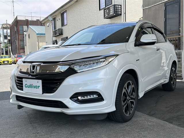 ホンダ ヴェゼル ハイブリッド Z ホンダセンシング 京都府 2020(令2)年 7.4万km パール ワンオーナー /ホンダセンシング/衝突軽減ブレーキ/路外脱却抑制装置/車線維持支援システム/純正メーカーOPSDナビ　/フルセグTV　/禁煙車　/バックカメラ　/LEDライト　/クルーズコントロール　/パドルシフト　/スマートキー　/前方シートヒーター/ハーフレザー　/前方純正ドライブレコーダー/純正AW17インチ/ウィンカーミラー/ビルトインETC/パワーウィンドウ/パワーステアリング/スペアキー有/CD/DVD再生機能有/iPod/AUX/純正フロアマット/リアエアロ/横滑り防止装置/Wサイドエアバッグ/ワイパーデアイサー