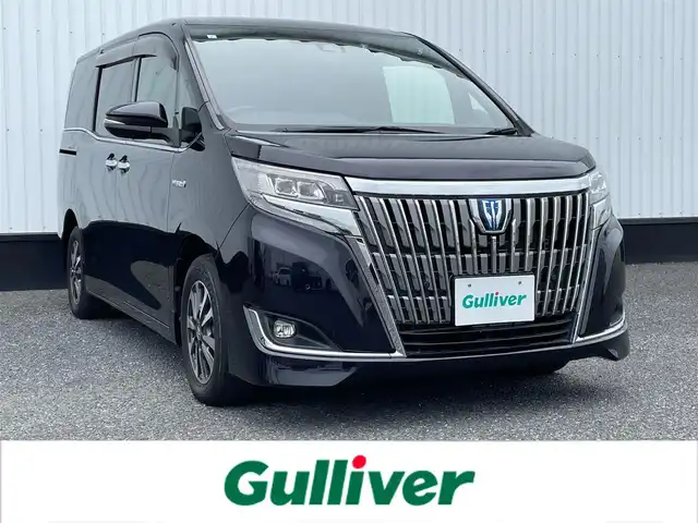 トヨタ エスクァイア ハイブリッド Gi プレミアムパッケージ 千葉県 2019(平31)年 4.8万km スパークリングブラックパールクリスタルシャイン 純正10インチナビ/(フルセグTV/BT/CD/DVD/FM/AM)/バックカメラ/衝突被害軽減システム/車線逸脱警報/クルーズコントロール/ハーフレザーシート/両側パワースライドドア/横滑り防止装置/ビルトインETC/アイドリングストップ/LEDヘッドライト/フォグランプ/オートライト/ウィンカーミラー/電動格納ミラー/純正15インチAW/シートヒーター/シートリフター/ステアリングヒーター/プッシュスタート/スマートキー/フロアマット/ドアバイザー/取扱説明書/保証書