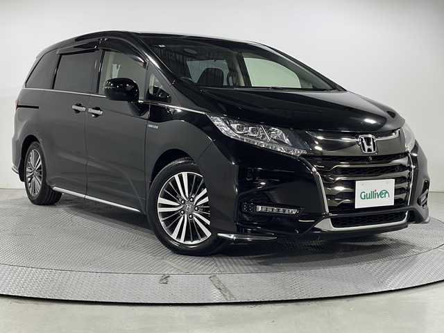 ホンダ オデッセイ ハイブリッド アブソルート・EXホンダセンジング 広島県 2020(令2)年 4.8万km プレミアムスパークルブラックパール 純正9型ナビ/純正フリップダウンモニター/マルチビューカメラ/スマートパーキングアシスト/両側パワースライドドア/ハーフレザーシート/パワーシート/シートヒーター/オットマン/ブラインドスポットモニター/コーナーセンサー/ホンダセンシング/・衝突軽減ブレーキ/・レーンキープアシスト/・アダプティブクルーズコントロール/・誤発進抑制機能/LEDヘッドランプ/オートライト/純正17インチAW/ETC2.0/USB/HDMI入力端子/AC100V/1500W給電
