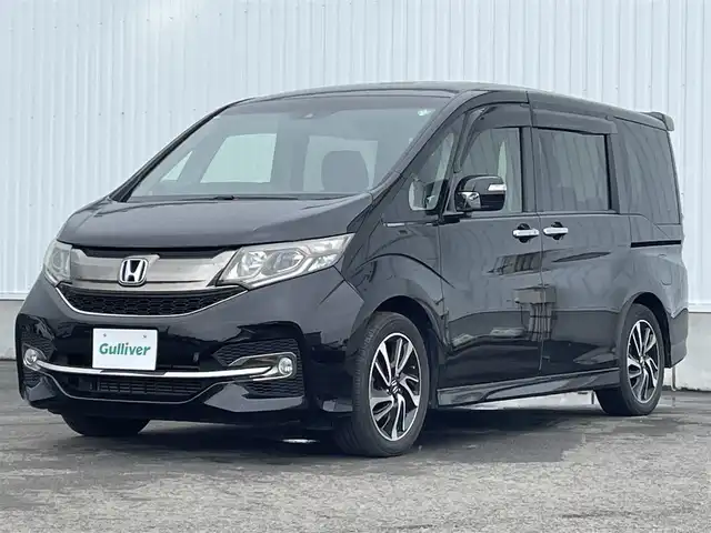 ホンダ ステップワゴン スパーダ クルスピセンシング 愛媛県 2017(平29)年 6.5万km プレミアムスパークルブラックパール 両側パワースライドドア/フリップダウンモニター/純正メモリナビ/CD/DVD/BT/MSV/iPod/フルセグTV/バックカメラ/ビルトインETC2.0/衝突被害軽減ブレーキ/レーンキープアシストシステム/アダプティブクルーズコントロール/ハーフレザーシート/D席＋N席シートヒーター/LEDヘッドライト/フォグライト/オートライト/純正フロアマット/後席サンシェード/純正16インチアルミホイール/スマートキー/プッシュスタート