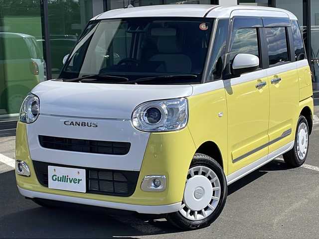ダイハツ ムーヴ キャンバス ストライプス G 道東・釧路十勝 2025(令7)年 2.2万km シャイニングホワイトパール/シトラスイエロークリスタルシャイン ・４WD/・純正メモリナビ/（CD・DVD・AM・FM・フルセグ・BT）/・バックカメラ/・ホットカップホルダー/・スマートアシスト/・先行車発信お知らせ警報/・衝突被害軽減ブレーキ/・車線逸脱防止機能/・標識認識/・両側パワースライドドア/・LEDヘッドライト/・オートライト/・アイドリングストップ/・前席シートヒーター/・スマートキー/・プッシュスタート/・純正フロアマット/・ドアバイザー/・電動格納ミラー/・保証書/・取扱説明書