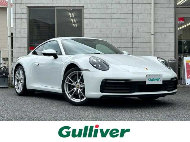 ポルシェ ９１１ カレラ 福岡県 2020(令2)年 2.7万km ピュアホワイト スポーツクロノパッケージ/・ストップウォッチ/・ドライブモードスイッチ(ステアリング)/・ローンチコントロール/ストレージパッケージ/純正10.9ディスプレイオーディオ/　(Bluetooth/ナビキット)/全方位カメラ/バック/フロント/サイドカメラ/格納式リヤスポイラー/アクティブサスペンションマネジメント/スタビリティマネジメント/アクティブセーフ(ブレーキアシスト)/アクティブレーンキープ/レーンキープアシスト/レーンチェンジアシスト/アダプティブクルーズコントロール/ナイトビューアシスト/パークアシスト/オートライト/タイヤ空気圧モニタリング/マニュアルモード/純正アルミホイール(前輪19インチ/後輪20インチ)/黒色レザーシート/シートヒーター付きパワーシート(D/N)/革巻きステアリング/ステアリングスイッチ/パドルシフト/スーパーキャットレーダー探知機【Z1100】/ユピテル前後ドライブレコーダー【SN-TW90di】/ISOFIX/スペアキー×1/保証書/取扱説明書