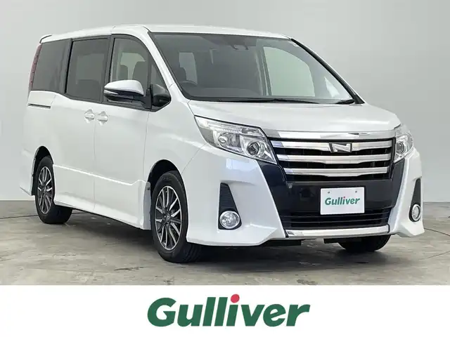 トヨタ ノア Si 千葉県 2016(平28)年 7万km ホワイトパールクリスタルシャイン 禁煙車/トヨタセーフティーセンス/　・プリクラッシュセーフティ/　・レーンディパーチャーアラート/　・オートマチックハイビーム/　・先行車発進お知らせ/純正9インチメモリナビ/　CD/DVD/BT/フルセグTV/フリップダウンモニター/両側パワースライドドア/バックカメラ/ビルトインETC/電動格納ミラー/革巻きステアリング/ステアリングスイッチ/純正フロアマット/LEDヘッドライト/純正16インチアルミホイール