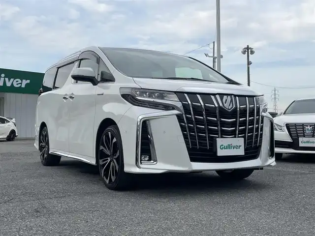 トヨタ アルファードハイブリット エグゼクティブ ラウンジ S 千葉県 2020(令2)年 5.3万km ホワイトパールクリスタルシャイン JBLプレミアムサウンド/リヤエンターテイメントシステム/黒レザーシート/純正9インチSDナビ/・CD/DVD/MSV/Bluetooth/フルセグ/パノラミックビューカメラ/両後パワースライドドア/パワーバックドア/モデリスタ20インチアルミホイール/前席パワーシート/1列目2列目シートヒーター/1列目2列目シートベンチレーション/デジタルインナーミラー/パーキングアシスト/トヨタセーフティーセンス/・プリクラッシュセーフティー/・レーンディパーチャーアラート/・パーキングサポートブレーキ/・リヤクロストラフィックアラート/・ロードサインアシスト/・アダプティブクルーズコントロール/・ブラインドスポットモニター/AC100V1500W電源/ウッドコンビステアリング/ステアリングヒーター/スマートキー/ビルトインETC/純正LEDヘッドライト/フォグランプ/前後コーナーセンサー/純正17インチアルミホイール車載/サイド＆カーテンエアバッグ/ニーエアバッグ