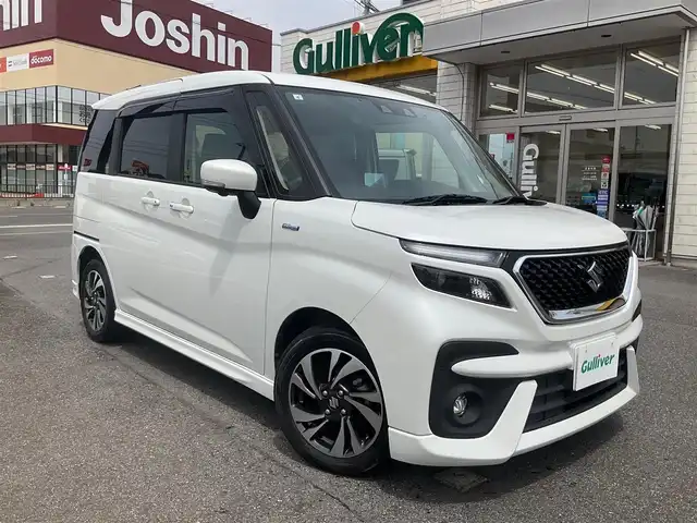 スズキ ソリオ バンディット HV MV 滋賀県 2021(令3)年 3.2万km ピュアホワイトP 車検8年4月まで/スズキセーフティサポート/純正9インチナビ/Bluetooth、DVD、CD、フルセグテレビ/全方位モニター、バックカメラ/ビルトインETC/前後ドライブレコーダー/前席シートヒーター/両側パワースライドドア/ヘッドアップディスプレイ/後部席パーソナルテーブル/純正LEDヘッドライト、LEDフォグランプ/純正15インチアルミホイール/取扱説明書/保証書