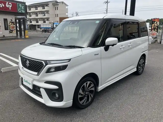 スズキ ソリオ バンディット HV MV 滋賀県 2021(令3)年 3.2万km ピュアホワイトP 車検8年4月まで/スズキセーフティサポート/純正9インチナビ/Bluetooth、DVD、CD、フルセグテレビ/全方位モニター、バックカメラ/ビルトインETC/前後ドライブレコーダー/前席シートヒーター/両側パワースライドドア/ヘッドアップディスプレイ/後部席パーソナルテーブル/純正LEDヘッドライト、LEDフォグランプ/純正15インチアルミホイール/取扱説明書/保証書