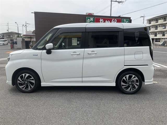 スズキ ソリオ バンディット HV MV 滋賀県 2021(令3)年 3.2万km ピュアホワイトP 車検8年4月まで/スズキセーフティサポート/純正9インチナビ/Bluetooth、DVD、CD、フルセグテレビ/全方位モニター、バックカメラ/ビルトインETC/前後ドライブレコーダー/前席シートヒーター/両側パワースライドドア/ヘッドアップディスプレイ/後部席パーソナルテーブル/純正LEDヘッドライト、LEDフォグランプ/純正15インチアルミホイール/取扱説明書/保証書