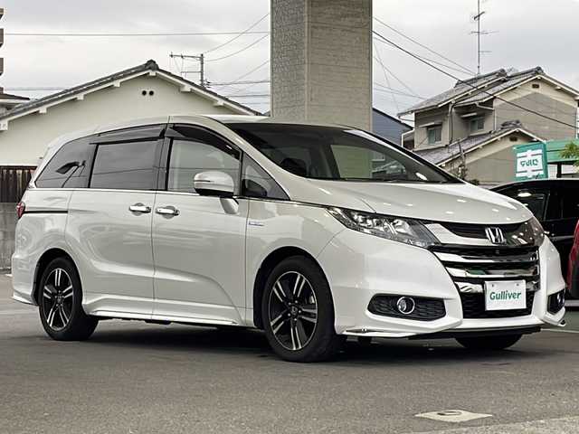 ホンダ オデッセイ ハイブリッド アブソルートセンシングEXパック 愛媛県 2016(平28)年 5.3万km ホワイトオーキッドパール ワンオーナー/純正ナビ/・Bluetooth/・全方位カメラ/・フルセグ/両側パワースライドドア/ホンダセンシング /プリクラッシュ/レーダークルーズコントロール/ハーフレザーシート/D席パワーシート/オットマン/前後ドライブレコーダー/100V充電/スマートキー/プッシュスタート/純正アルミホイール/ドアバイザー/USB端子