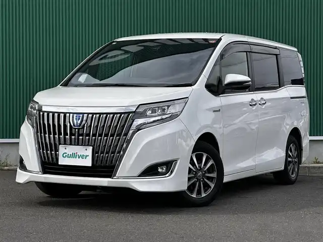トヨタ エスクァイア ハイブリッド Gi 宮城県 2017(平29)年 10.5万km ホワイトパールクリスタルシャイン Toyota Safety Sense/純正10型ナビ/【CD・DVD・SD・BT・フルセグTV】/バックカメラ/両側パワースライドドア/純正フリップダウンモニター/ブラック合皮シート/シートヒーター/シートリフター/クルーズコントロール/リアサンシェード/プリクラッシュセーフティ/レーンディパーチャートアラート/先行発進告知/オートハイビーム/オートライト/LEDヘッドライト/フォグライト/ウッドコンビステアリング/リアサンシェード/スマートキー/ETC