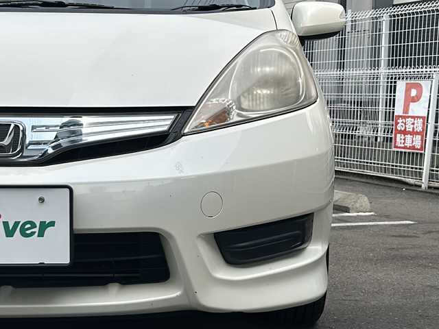 ホンダ フィット シャトル ハイブリッド 京都府 2012(平24)年 11.2万km プレミアムホワイトパール 純正ナビＶＸＭ－１２８ＶＳ　/ＣＤ／ＤＶＤ／ＴＶ／ＵＳＢ　/バックカメラ　/ハーフレザーシート　/ドライブレコーダー　/ＥＴＣ　/社外１５ＡＷ　/キーレスキー　/スペアキー　/電格ミラー　/ＡＢＳ　/保証書　/取説