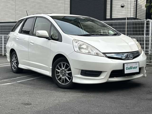 ホンダ フィット シャトル ハイブリッド 京都府 2012(平24)年 11.2万km プレミアムホワイトパール 純正ナビＶＸＭ－１２８ＶＳ　/ＣＤ／ＤＶＤ／ＴＶ／ＵＳＢ　/バックカメラ　/ハーフレザーシート　/ドライブレコーダー　/ＥＴＣ　/社外１５ＡＷ　/キーレスキー　/スペアキー　/電格ミラー　/ＡＢＳ　/保証書　/取説