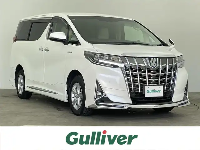 トヨタ アルファードハイブリット X 千葉県 2019(令1)年 5.8万km ホワイトパールクリスタルシャイン 禁煙車/モデリスタエアロ（F/S/R）/純正１０型ナビ（NSZN-Z68T）/AM＆FM＆Bluetooth＆フルセグTV＆CD＆DVD/両側電動スライドドア　/トヨタセーフティセンス　/プリクラッシュセーフティ/レーダークルーズコントロール　/ビルトインＥＴＣ/レザー調シートカバー（ベージュ）　/１００Ｖ電源　/純正フロアマット　/ＬＥＤヘッドライト/バックカメラ/アイドリングストップ/ウィンカーミラー/ドアバイザー/プッシュスタート