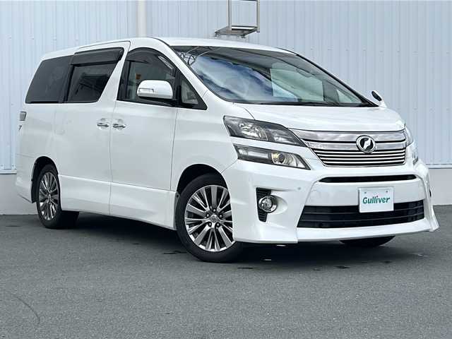 トヨタ ヴェルファイア 2．4Z ゴールデンアイズⅡ 三重県 2014(平26)年 7.3万km ホワイトパールクリスタルシャイン ALPINE10型ナビ /ALPINE10型後席モニター /バックカメラ /ETC /前後コーナーセンサー /AC100V充電 /両側パワースライドドア/スペアキー /オットマン /クルーズコントロール /純正フロアマット/ウッドコンビステアリング/ステアリングスイッチ/ハーフレザーシート /電動格納ミラー/禁煙車