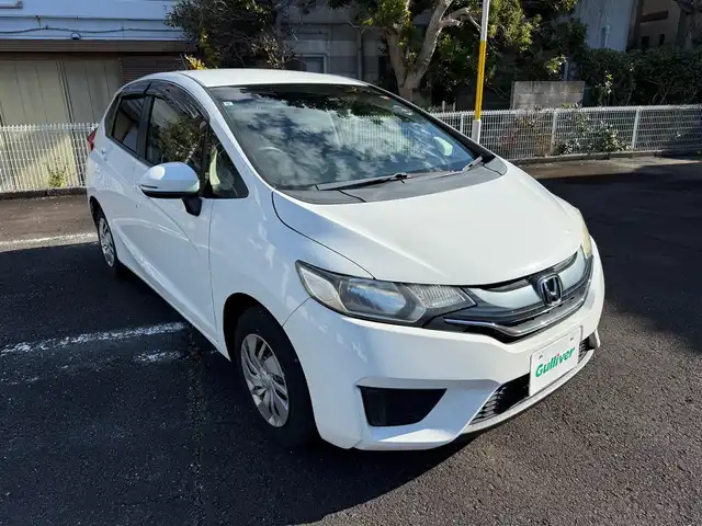 ホンダ フィット 13G Fパッケージ 静岡県 2015(平27)年 6万km タフタホワイト ワンオーナー/　・新車時保証書有り/走行距離：59/302Km(登録時)/車検：令和8年9月6日　迄/アイドリングストップ/純正ディスプレイオーディオ/バックカメラ/スマートキー×2/プッシュスタート/ウインカードアミラー/純正ドアバイザー/純正フロアマット/Wエアバック＋ABS/取説有り