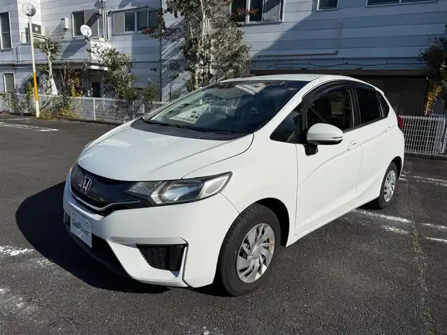 ホンダ フィット 13G Fパッケージ 静岡県 2015(平27)年 6万km タフタホワイト ワンオーナー/　・新車時保証書有り/走行距離：59/302Km(登録時)/車検：令和8年9月6日　迄/アイドリングストップ/純正ディスプレイオーディオ/バックカメラ/スマートキー×2/プッシュスタート/ウインカードアミラー/純正ドアバイザー/純正フロアマット/Wエアバック＋ABS/取説有り