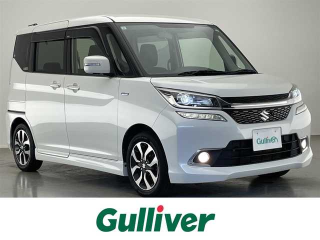 スズキ ソリオ バンディット HV MV 福岡県 2015(平27)年 7.6万km ピュアホワイトP (株)IDOMが運営する【じしゃロン八幡西店】の自社ローン専用車両になります。こちらは現金またはオートローンご利用時の価格です。自社ローンご希望の方は別途その旨お申付け下さい/純正ナビ/フルセグTV/シートヒーター/両側パワスラ/全方位モニター/LEDヘッドライト/禁煙車/フォグランプ/オートライト/純正フロアマット/Bluetooth/USB入力端子