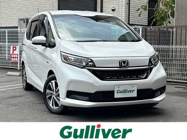 ホンダ フリード ハイブリット G ホンダセンシング 茨城県 2020(令2)年 6.7万km プラチナホワイトパール 純正ナビ/(Gathers/VXM-207VFNi)/フルセグＴＶ　ＢＴ　ＣＤ／ＤＶＤ　/純正フリップダウンモニター/前席シートヒーター　/ホンダセンシング　/レーンキープアシスト/コーナーセンサー/クルーズコントロール/オートドアミラー/アクティブコーナリングライト/LEDヘッドライト/プラズマクラスター/両側パワスラ　/バックカメラ/３列シート　/チップアップシート　　/ビルトインＥＴＣ/保証書/取扱説明書/点検記録簿