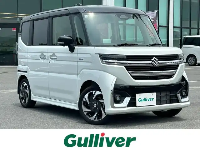 スズキ スペーシア カスタム HYBRID XS 奈良県 2024(令6)年 0.4万km ピュアホワイトパール/ブラック2トーン 両側パワースライドドア/純正ナビ(フルセグTV/AM・FM/BT/AppleCarPlay/AndroidAuto)/アラウンドビューモニター/ETC/ヘッドアップディスプレイ/シートヒーター(D/N席)/ステアリングヒーター/LEDヘッドライト/フォグランプ/後席サンシェード/純正15インチアルミホイール/純正フロアマット