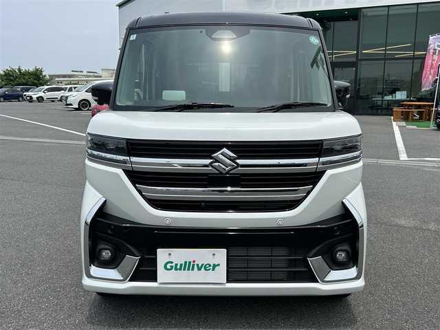 スズキ スペーシア カスタム HYBRID XS 奈良県 2024(令6)年 0.4万km ピュアホワイトパール/ブラック2トーン 両側パワースライドドア/純正ナビ(フルセグTV/AM・FM/BT/AppleCarPlay/AndroidAuto)/アラウンドビューモニター/ETC/ヘッドアップディスプレイ/シートヒーター(D/N席)/ステアリングヒーター/LEDヘッドライト/フォグランプ/後席サンシェード/純正15インチアルミホイール/純正フロアマット