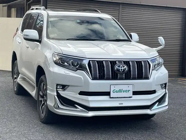 トヨタ ランドクルーザー プラド TX Lパッケージ 千葉県 2022(令4)年 4万km ホワイトパールクリスタルシャイン ワンオーナー/モデリスタフロントエアロ/モデリスタリアエアロ/モデリスタリアスポイラー/モデリスタマフラー/純正19インチアルミホイール/純正9インチナビ/クルーズコントロール/パワーバックドア/プッシュスタート/センターデフロック /ダウンヒルアシスト機能/オートハイビーム/ETC2.0/ヘッドライトウォッシャー/アイドルアップ（寒冷地仕様）/ヒルスタートアシスト/2nd START（雪道・泥道向け）/切替４WD/ドアバイザー/電動格納ミラー/ウィンカーミラー/保証書/取扱説明書、ナビ説明書